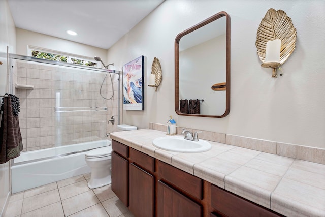 full bathroom featuring enclosed tub / shower combo, vanity, toilet, and tile patterned flooring