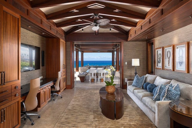 living room with ceiling fan, wooden walls, a water view, and beam ceiling