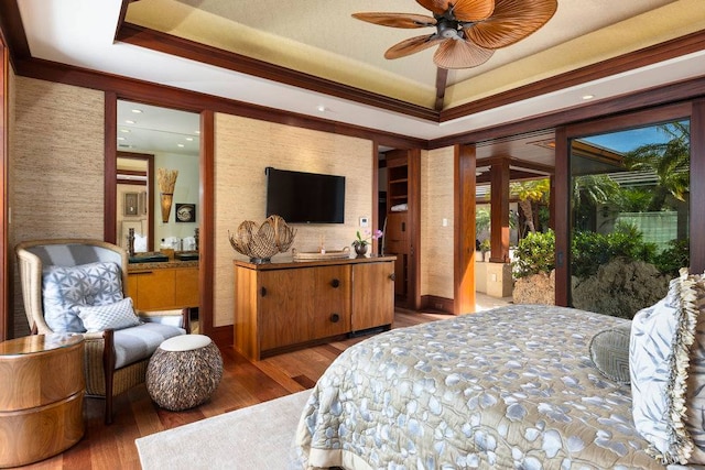 bedroom featuring access to exterior, a raised ceiling, ceiling fan, and dark hardwood / wood-style flooring