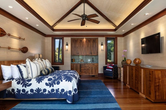 bedroom featuring ceiling fan, multiple windows, a tray ceiling, and dark wood-type flooring