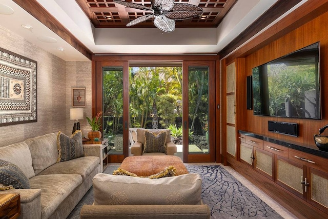 interior space with a raised ceiling, dark hardwood / wood-style floors, and ceiling fan