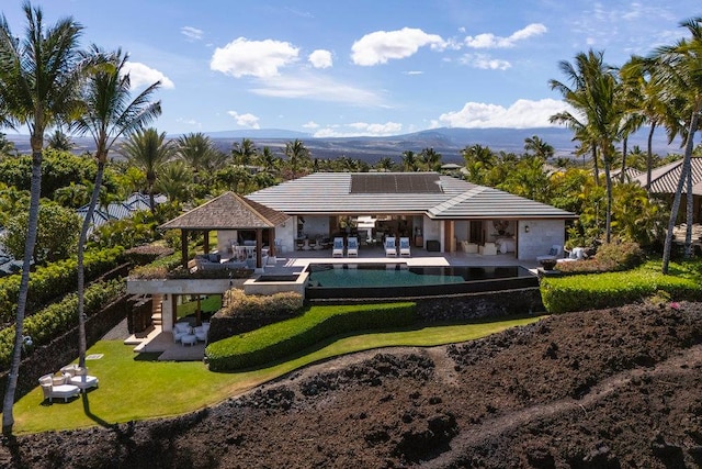 rear view of property featuring a patio area