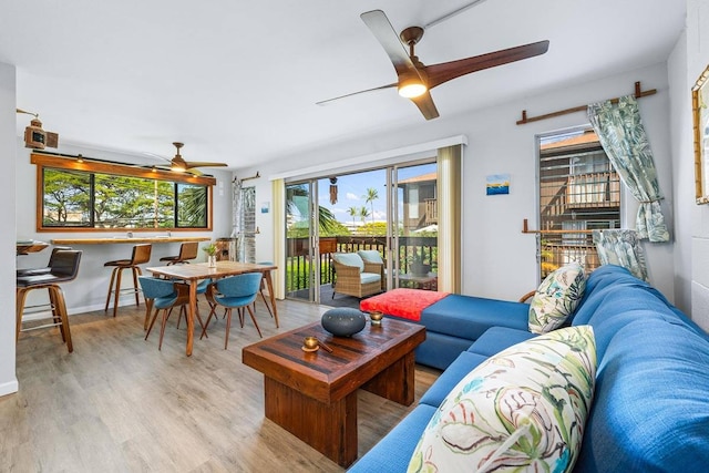 living room featuring light hardwood / wood-style floors and ceiling fan