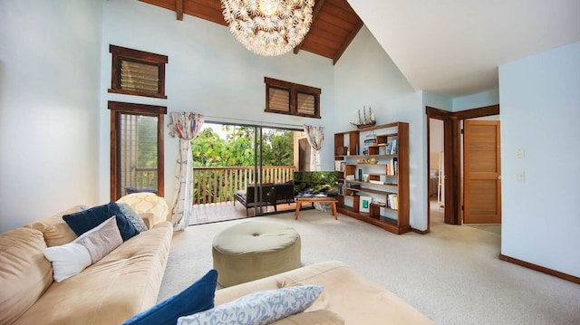 living area featuring a chandelier, carpet floors, high vaulted ceiling, and baseboards