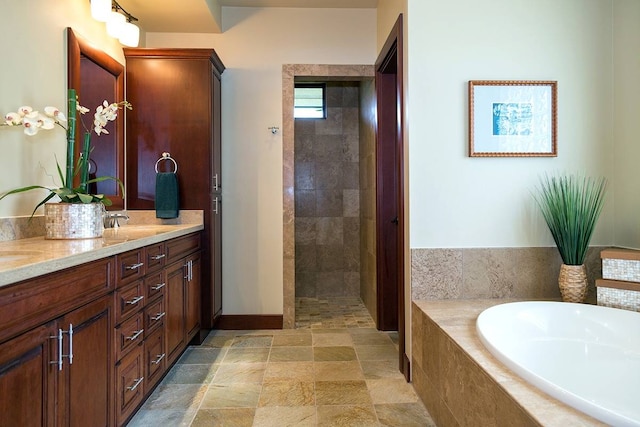 bathroom with dual bowl vanity, tile flooring, and plus walk in shower