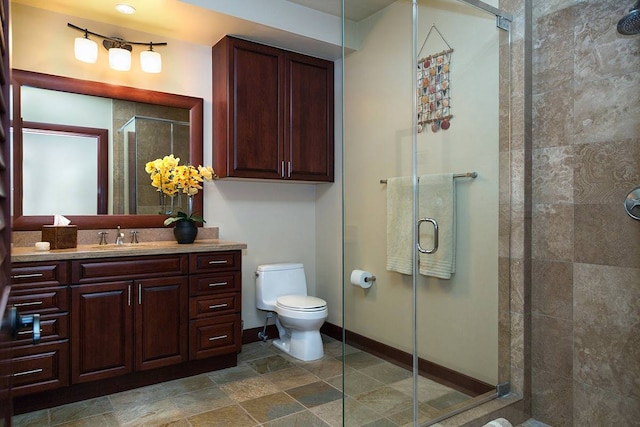 bathroom with tile floors, toilet, vanity, and a shower with door