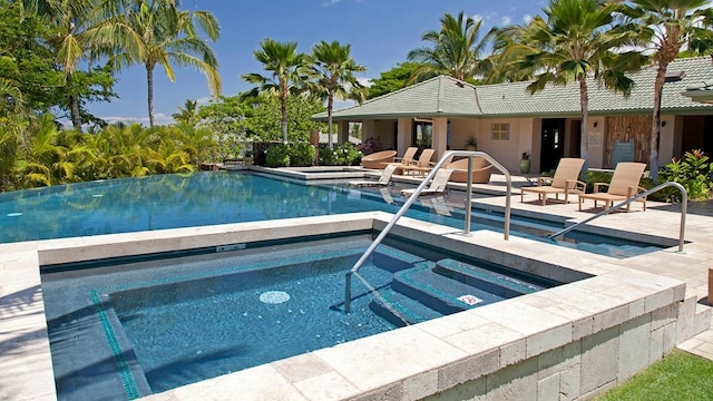 view of pool featuring an in ground hot tub and a patio area