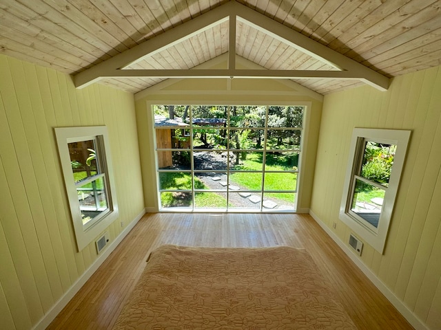 entryway featuring a healthy amount of sunlight, wooden ceiling, and light hardwood / wood-style floors