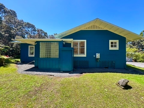 view of side of home with a lawn