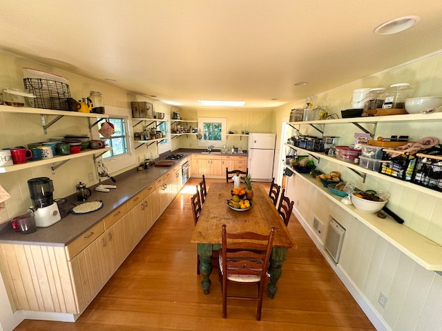 dining space with sink and light hardwood / wood-style flooring