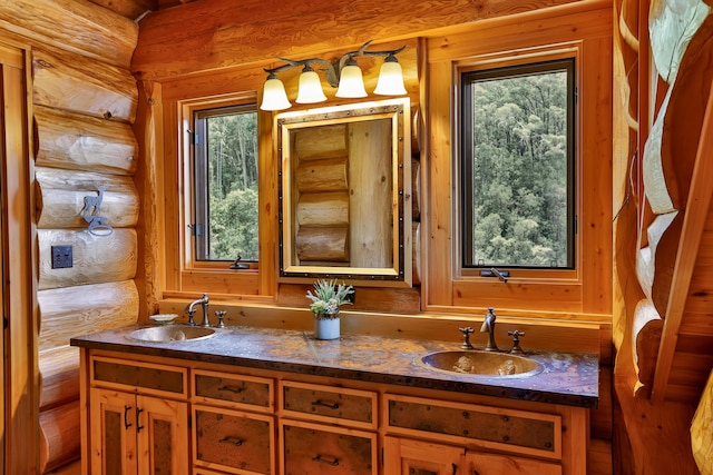 full bath with double vanity, rustic walls, and a sink