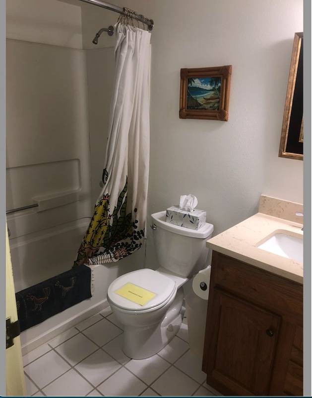 full bathroom with shower / bath combination with curtain, tile flooring, toilet, and vanity