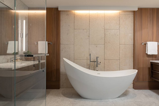 bathroom with tile walls, tile flooring, and vanity