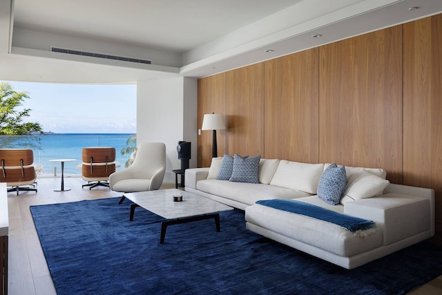 living room featuring a water view and hardwood / wood-style floors