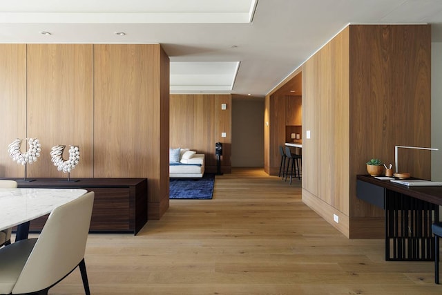 hall featuring wood walls and light wood-type flooring