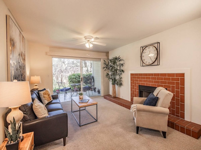 living room featuring ceiling fan, a fireplace, and carpet