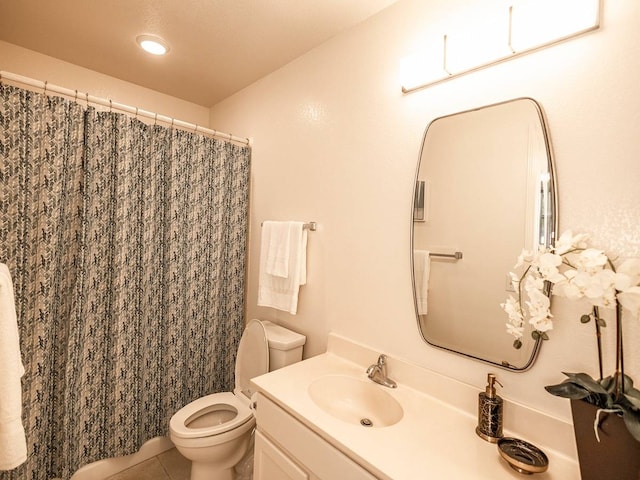 bathroom with curtained shower, vanity, toilet, and tile patterned floors