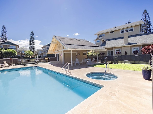 view of swimming pool featuring an in ground hot tub and a patio area