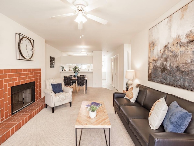 living room featuring ceiling fan, light colored carpet, and a brick fireplace