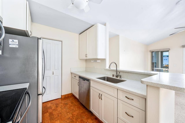 kitchen with stainless steel dishwasher, vaulted ceiling, ceiling fan, kitchen peninsula, and sink