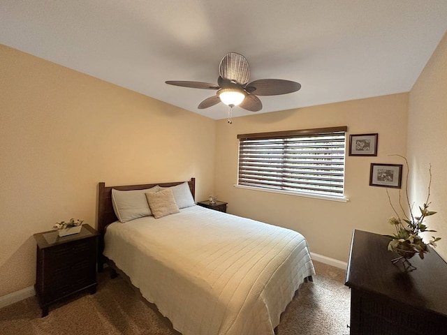 bedroom featuring ceiling fan and dark carpet