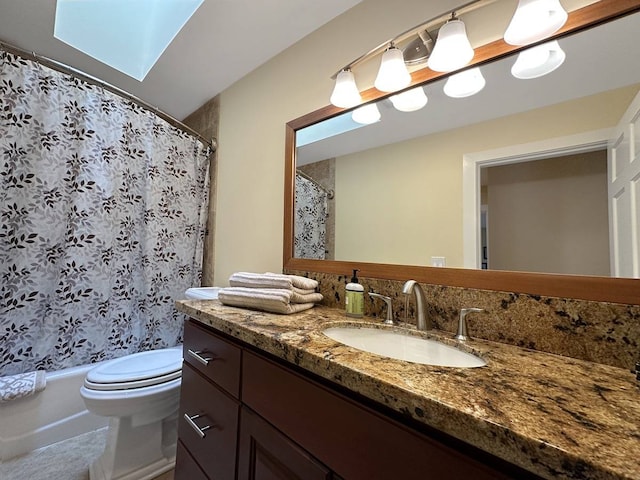 full bathroom featuring a skylight, vanity with extensive cabinet space, toilet, and shower / bathtub combination with curtain