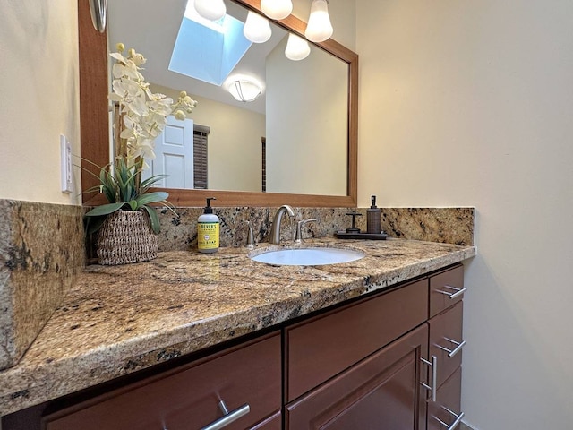 bathroom with a skylight and vanity