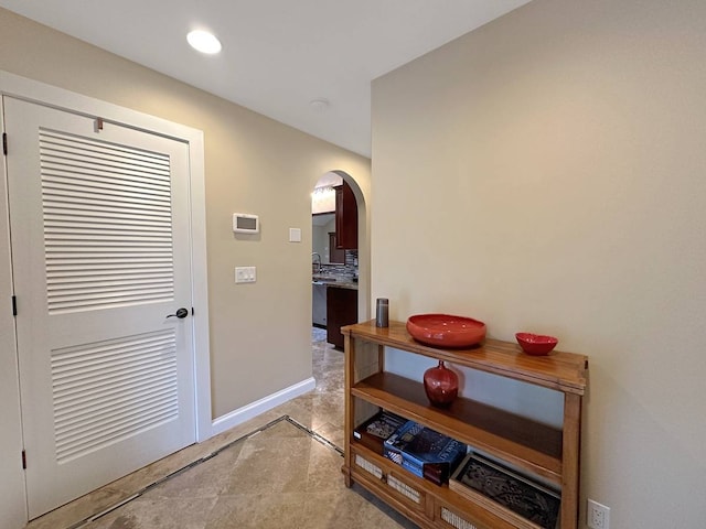 corridor featuring light tile floors