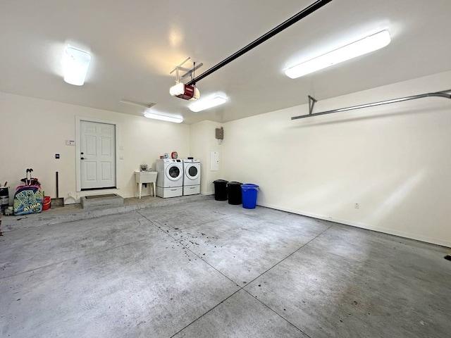 garage featuring washer and dryer and a garage door opener