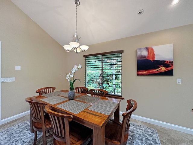 dining space with an inviting chandelier and vaulted ceiling