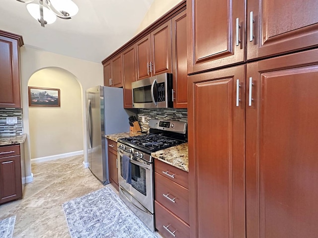 kitchen with a chandelier, stainless steel appliances, light tile flooring, light stone countertops, and tasteful backsplash