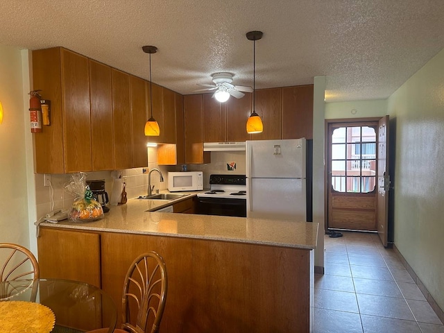 kitchen featuring light tile flooring, pendant lighting, ceiling fan, white appliances, and kitchen peninsula