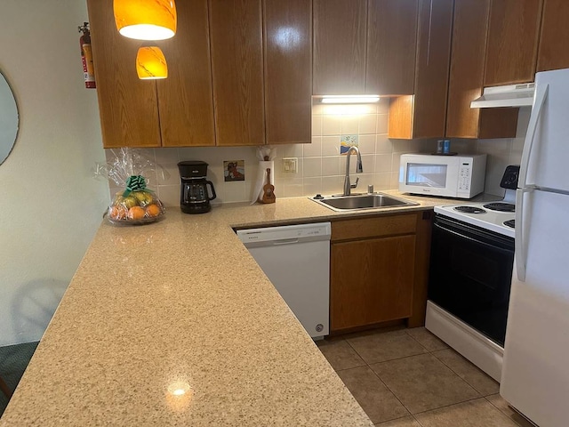 kitchen featuring white appliances, backsplash, sink, and light tile floors