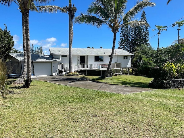 view of front of property with a trampoline, a garage, and a front lawn