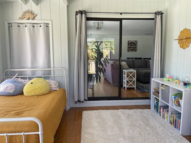 bedroom with dark hardwood / wood-style floors