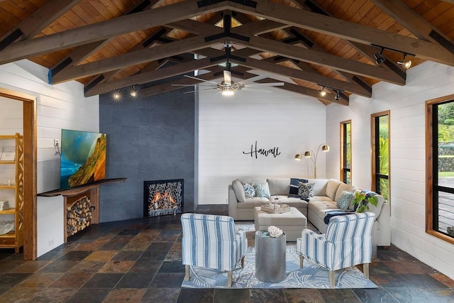 living area featuring wood ceiling, ceiling fan, lofted ceiling with beams, and stone tile floors