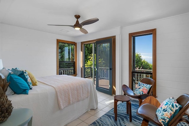 bedroom featuring light tile patterned floors, ceiling fan, multiple windows, and access to exterior