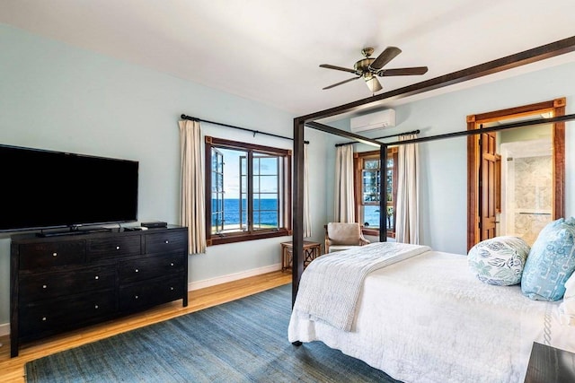 bedroom featuring ceiling fan, a water view, dark hardwood / wood-style floors, and a wall unit AC