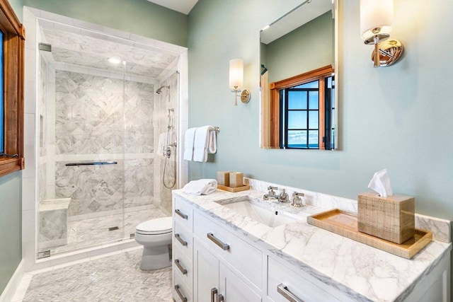 bathroom with tile floors, toilet, large vanity, and walk in shower