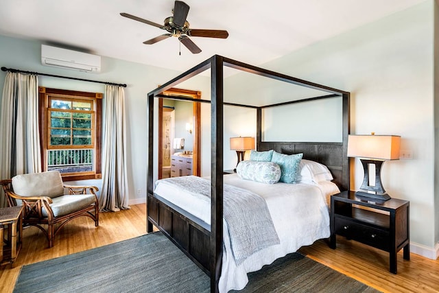 bedroom with light hardwood / wood-style flooring, ceiling fan, and a wall unit AC