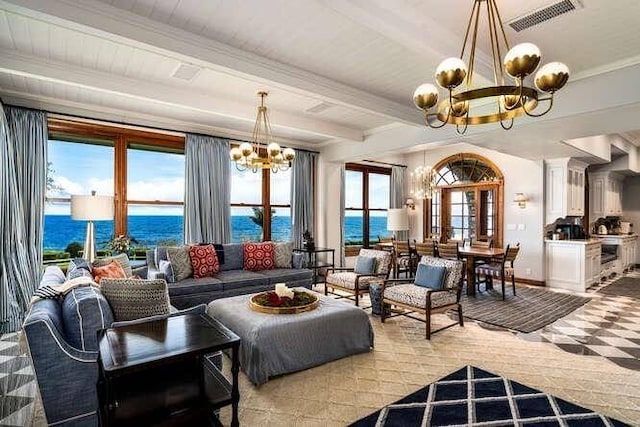 living room featuring a water view, a notable chandelier, and beam ceiling