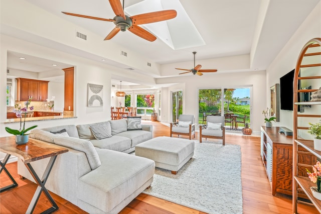 living room with ceiling fan and light hardwood / wood-style floors