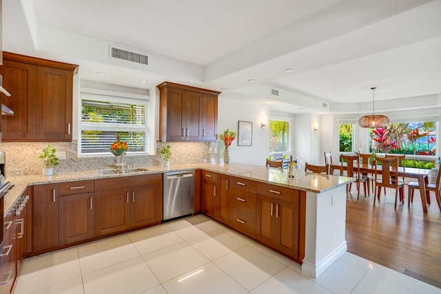 kitchen featuring kitchen peninsula, stainless steel dishwasher, plenty of natural light, and sink