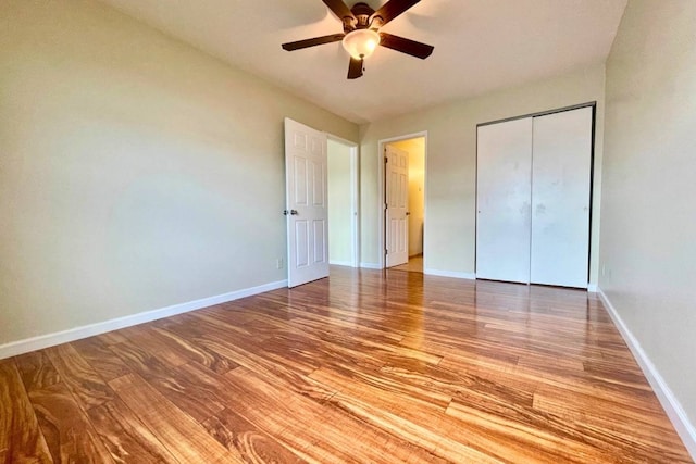 unfurnished bedroom featuring a closet, light hardwood / wood-style floors, and ceiling fan