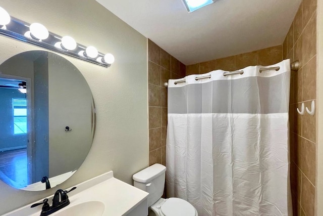 bathroom with ceiling fan, vanity, and toilet