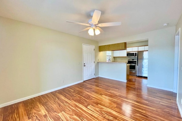 unfurnished living room featuring ceiling fan and light wood-type flooring