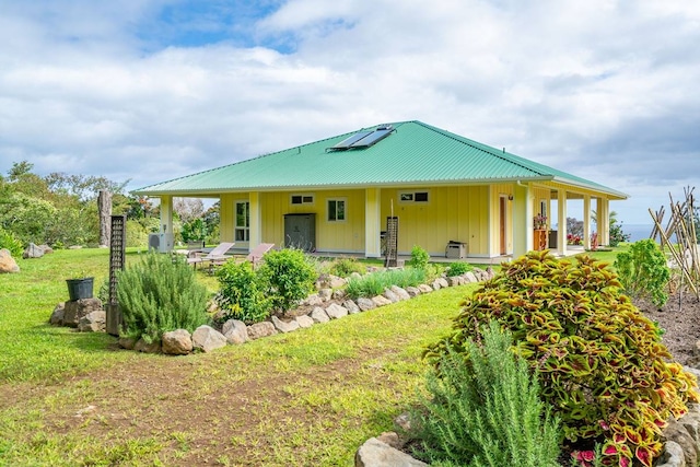 farmhouse with covered porch and a front lawn