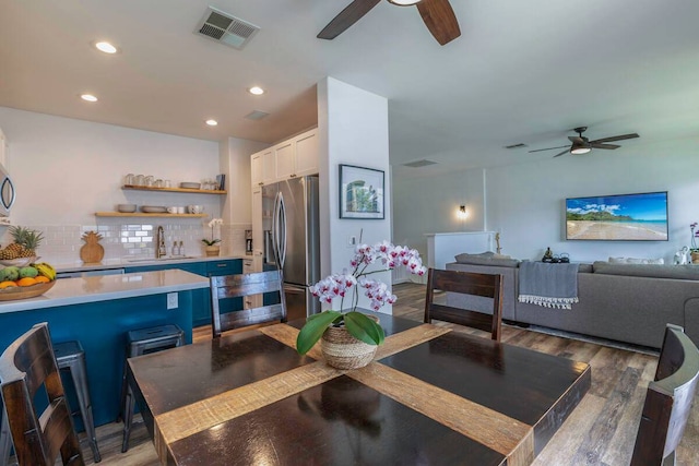 dining area with sink and dark wood-type flooring