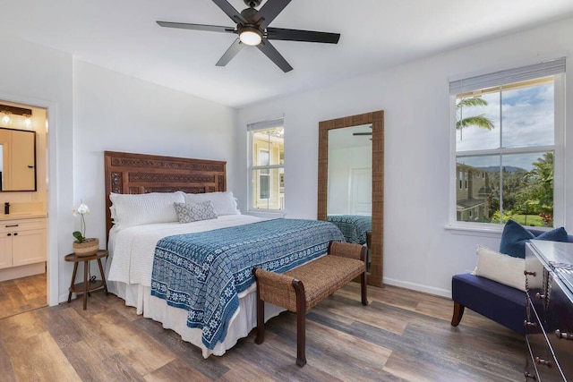 bedroom featuring ensuite bathroom, ceiling fan, and dark hardwood / wood-style flooring