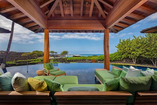 exterior space featuring a gazebo, a water view, and an outdoor hangout area